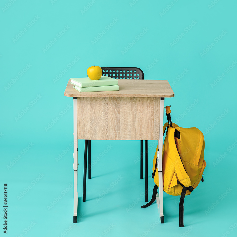 Modern school desk on color background