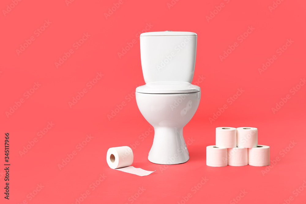 Toilet bowl with rolls of paper on color background