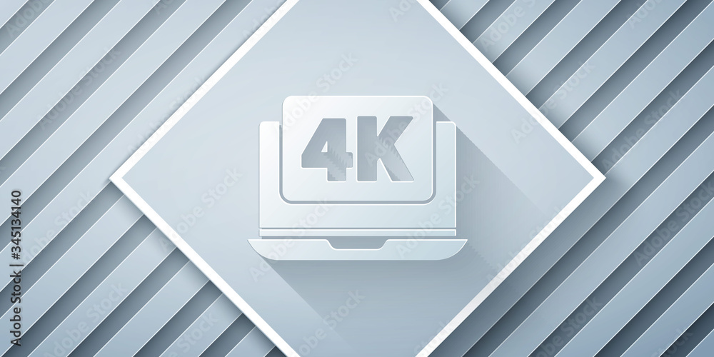 Paper cut Laptop screen with 4k video technology icon isolated on grey background. Paper art style. 