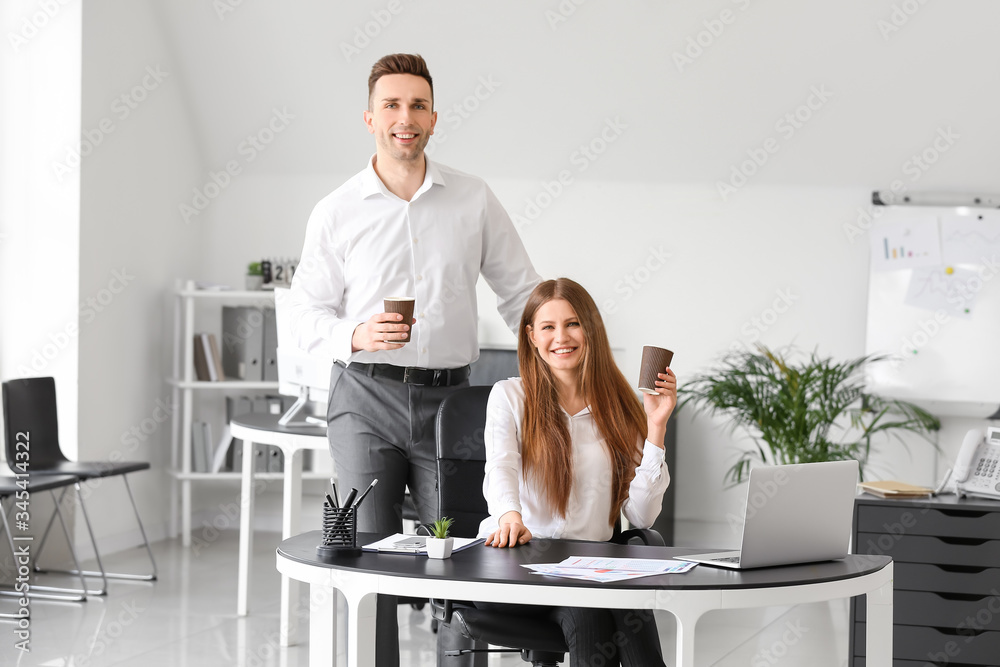 Young colleagues drinking coffee in office