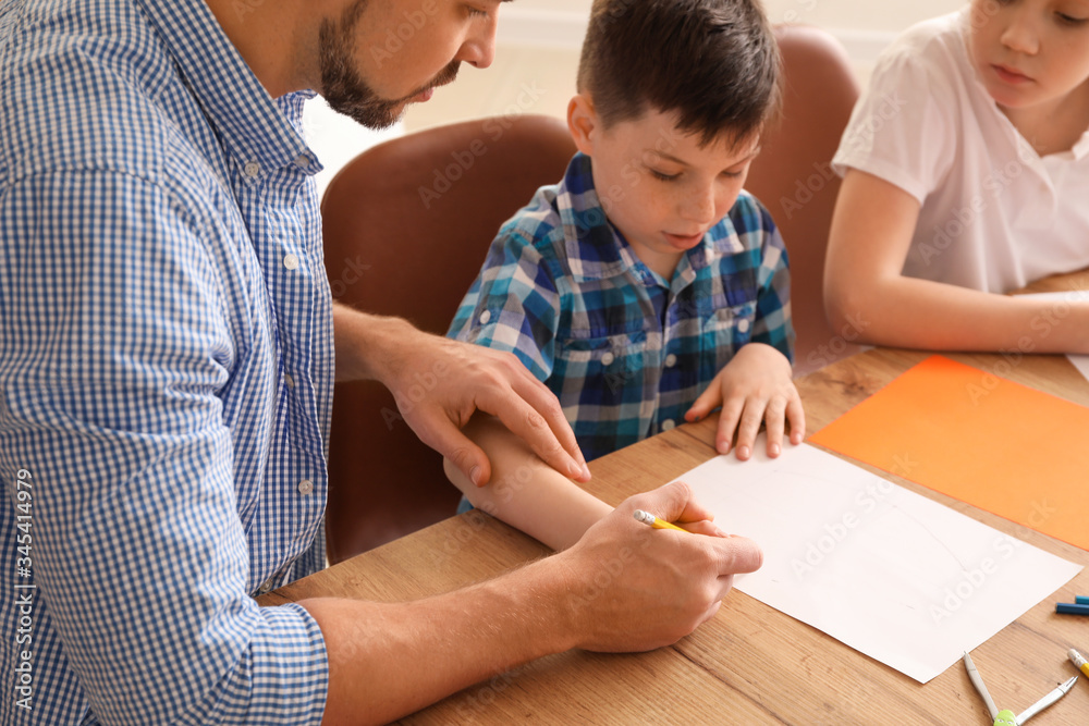 Drawing teacher giving optional classes at school