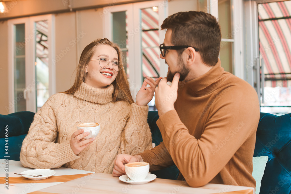 Young couple drinking coffee in cafe