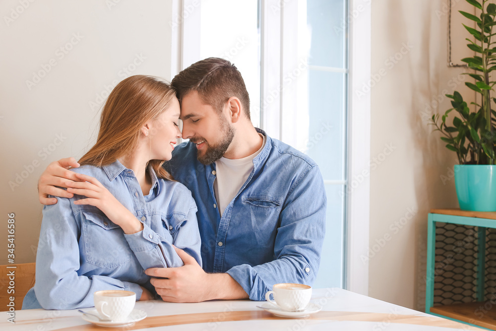 Young couple drinking coffee in cafe