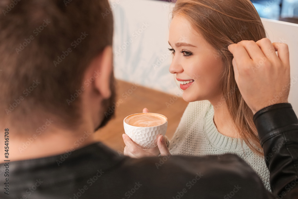 Young couple drinking coffee in cafe