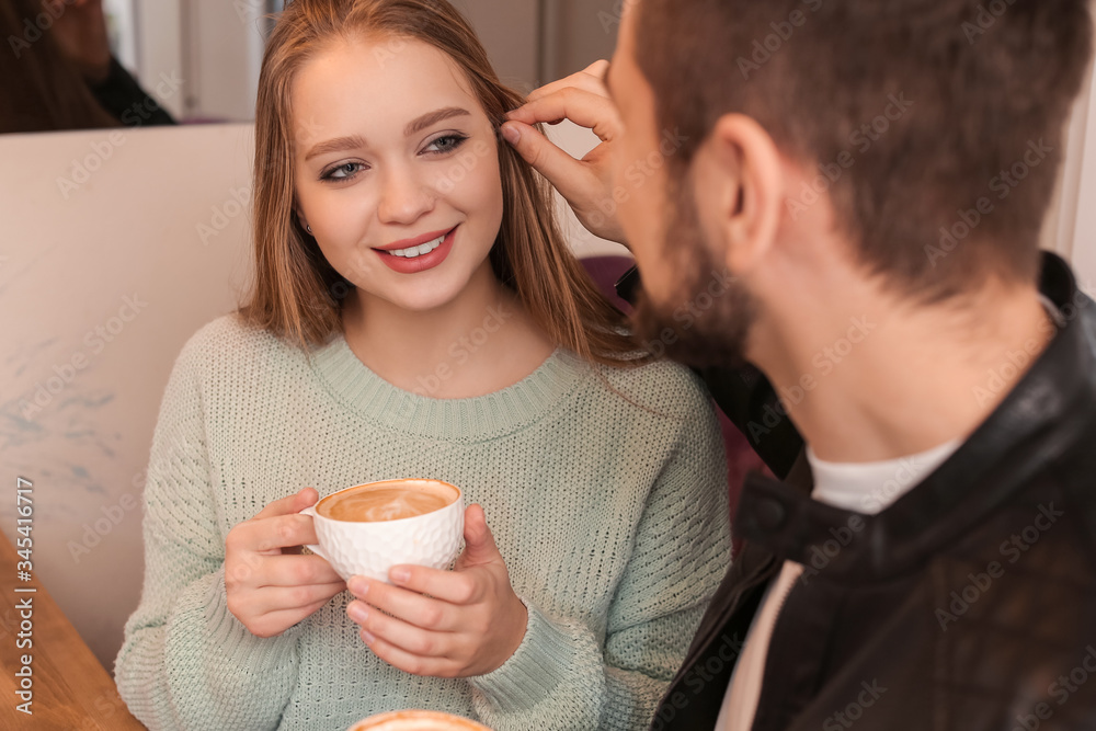 Young couple drinking coffee in cafe