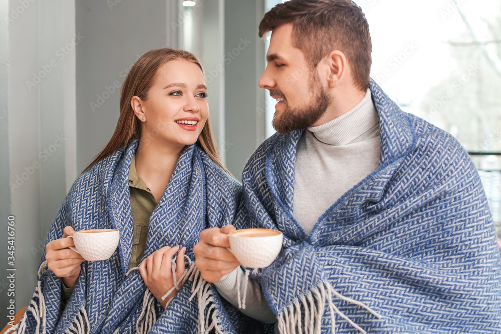 Young couple drinking coffee in cafe