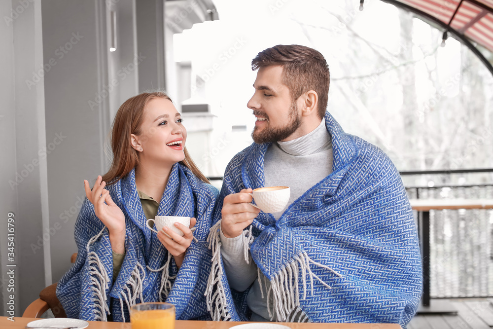 Young couple drinking coffee in cafe