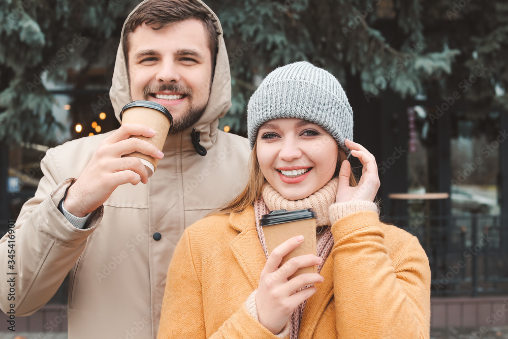 Young couple drinking coffee outdoors