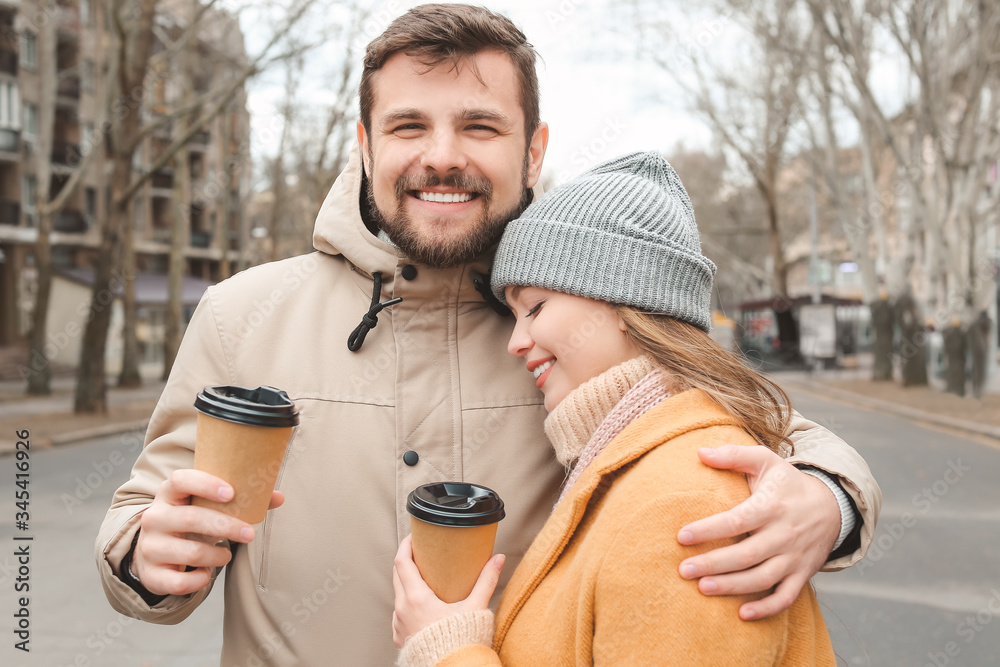 Young couple drinking coffee outdoors