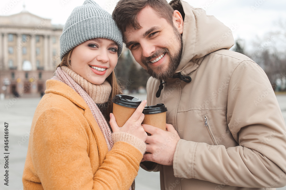 Young couple drinking coffee outdoors