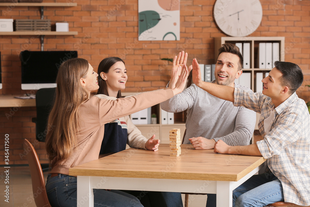 Team of business people holding hands together in office