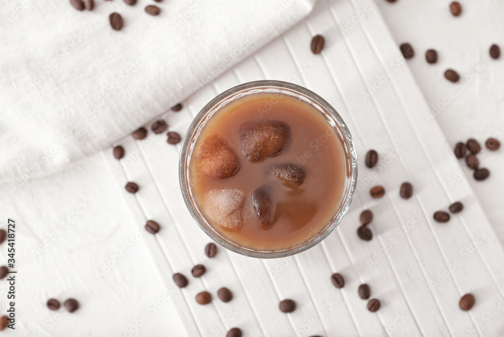 Glass of tasty iced coffee on table