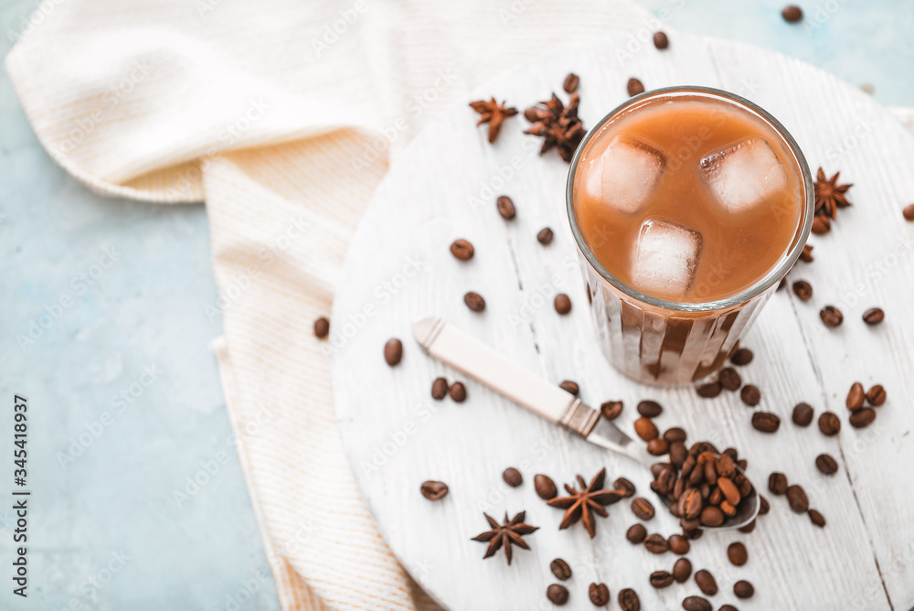 Glass of tasty iced coffee on table