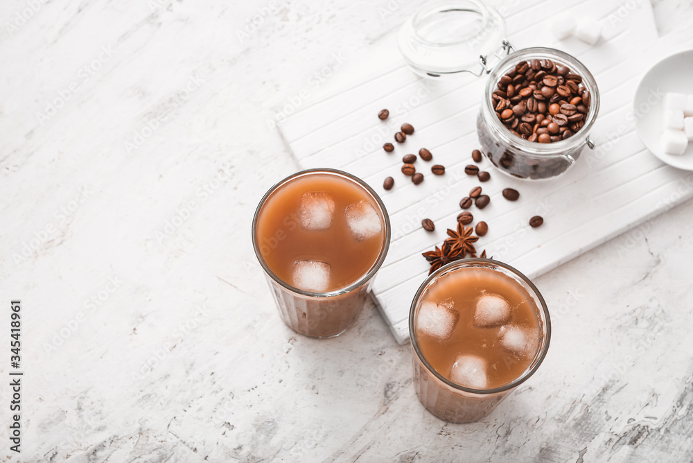 Glasses of tasty iced coffee on table