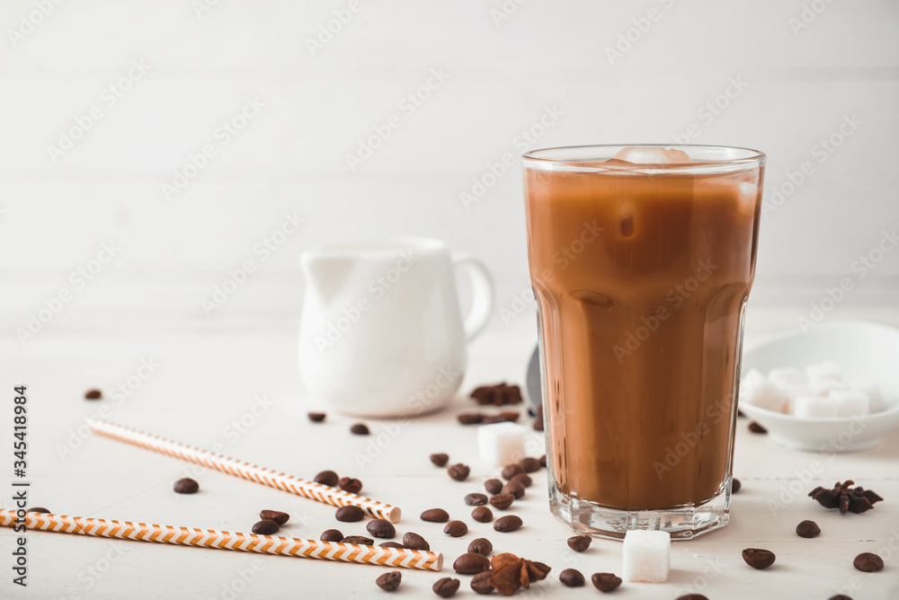 Glass of tasty iced coffee on table