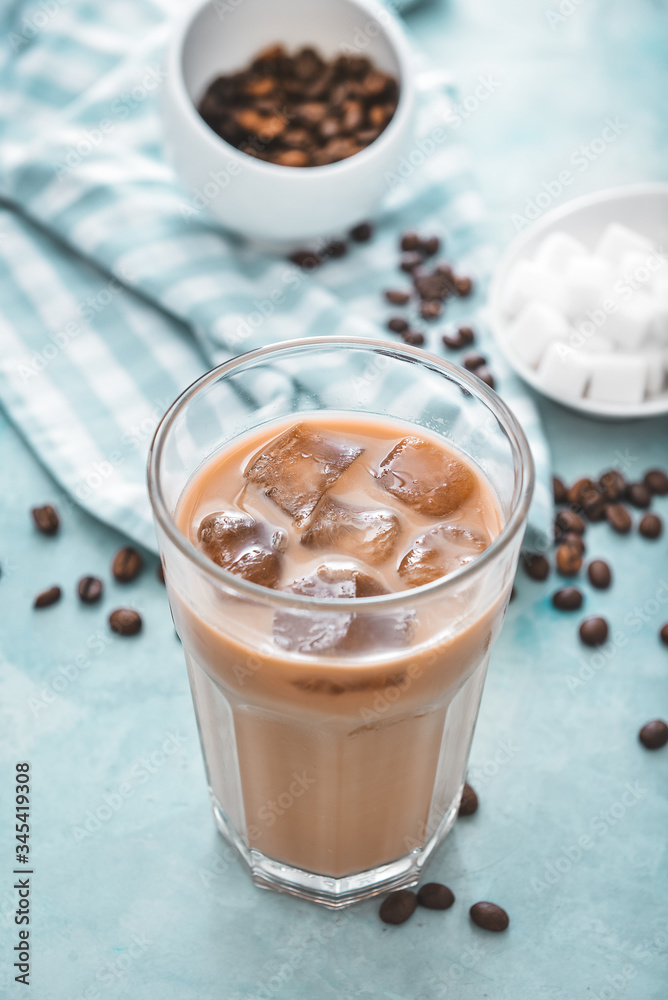 Glass of tasty iced coffee on color background