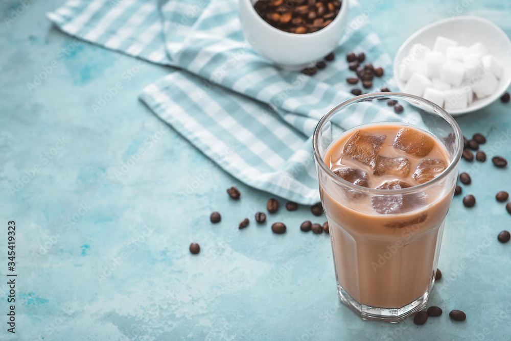 Glass of tasty iced coffee on color background