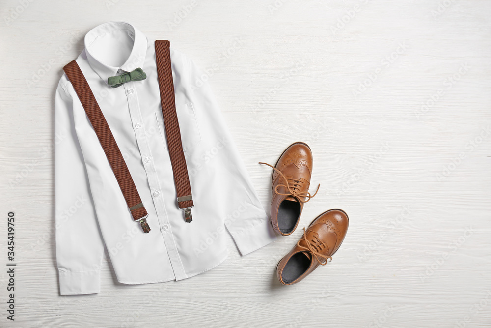 Stylish school uniform on white wooden background