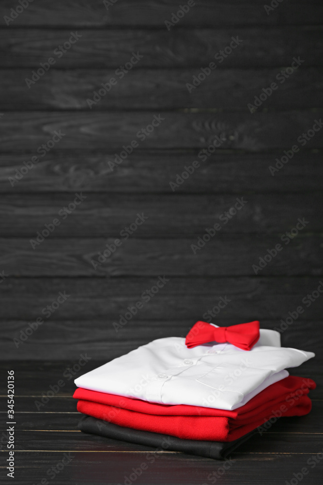 Stylish school uniform on dark wooden background