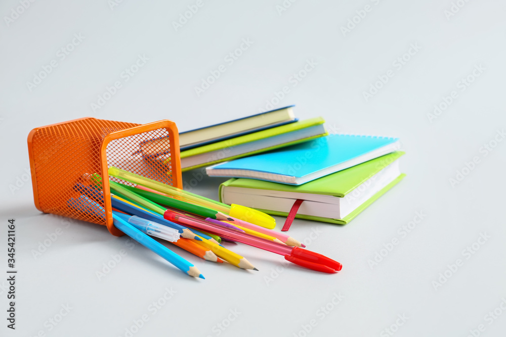 Holder with stationery on light background