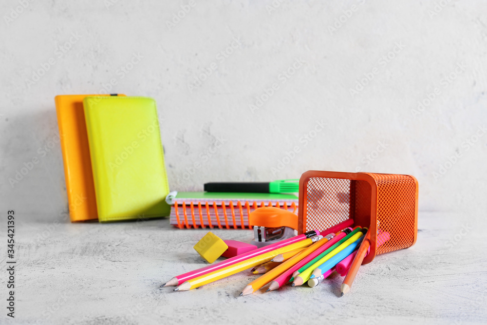 Holder with stationery on grey background