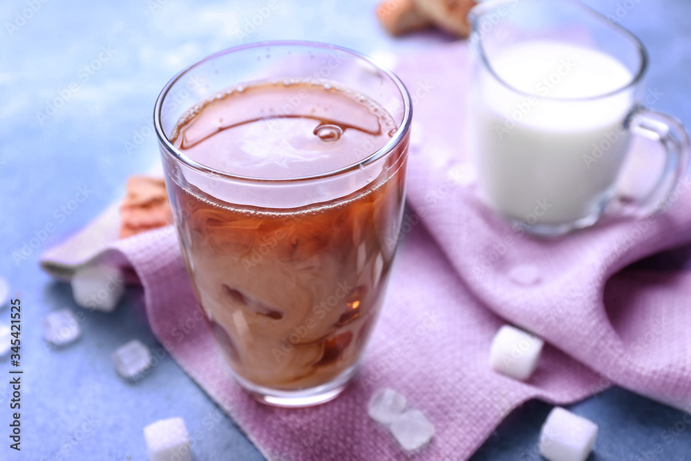 Glass of tasty iced coffee on color background