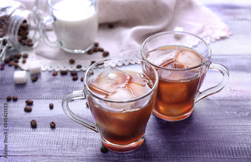 Cups of tasty iced coffee on table