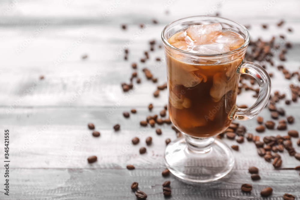 Cup of tasty iced coffee on table