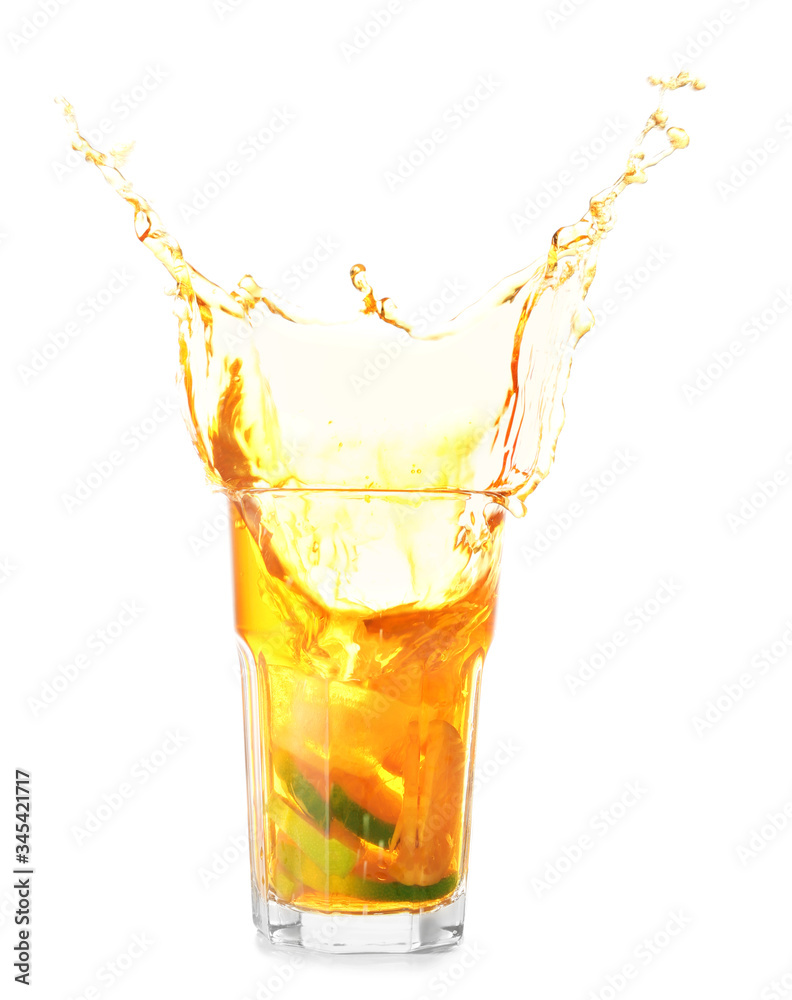 Glass of tasty cold ice tea with splash on white background