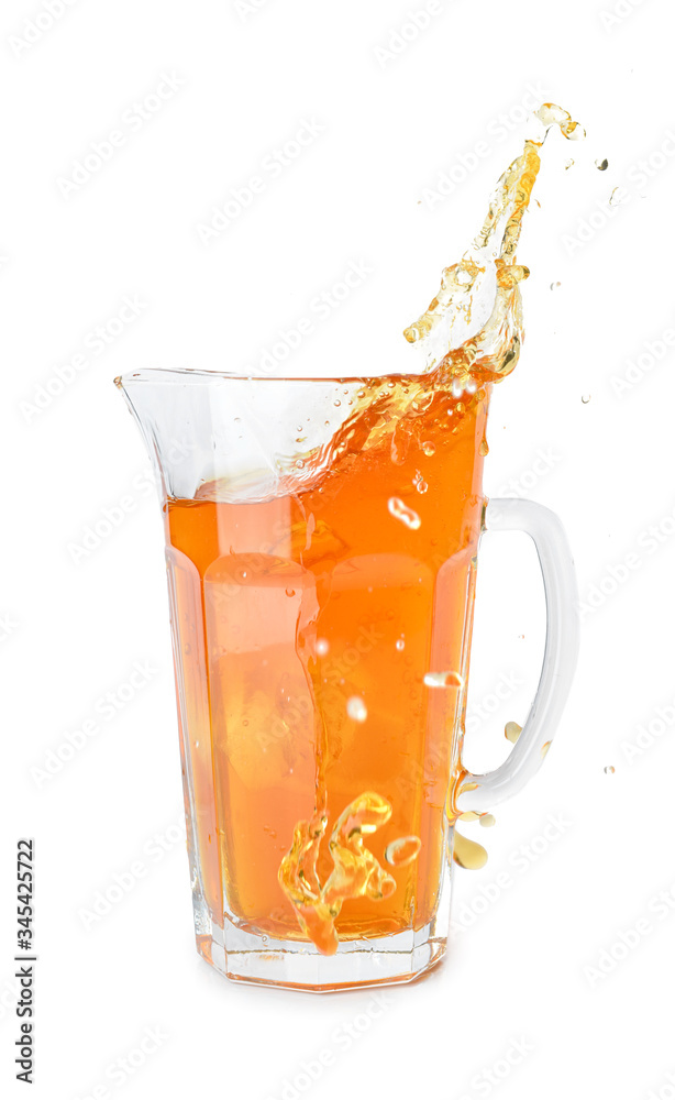 Jug of tasty cold ice tea with splash on white background