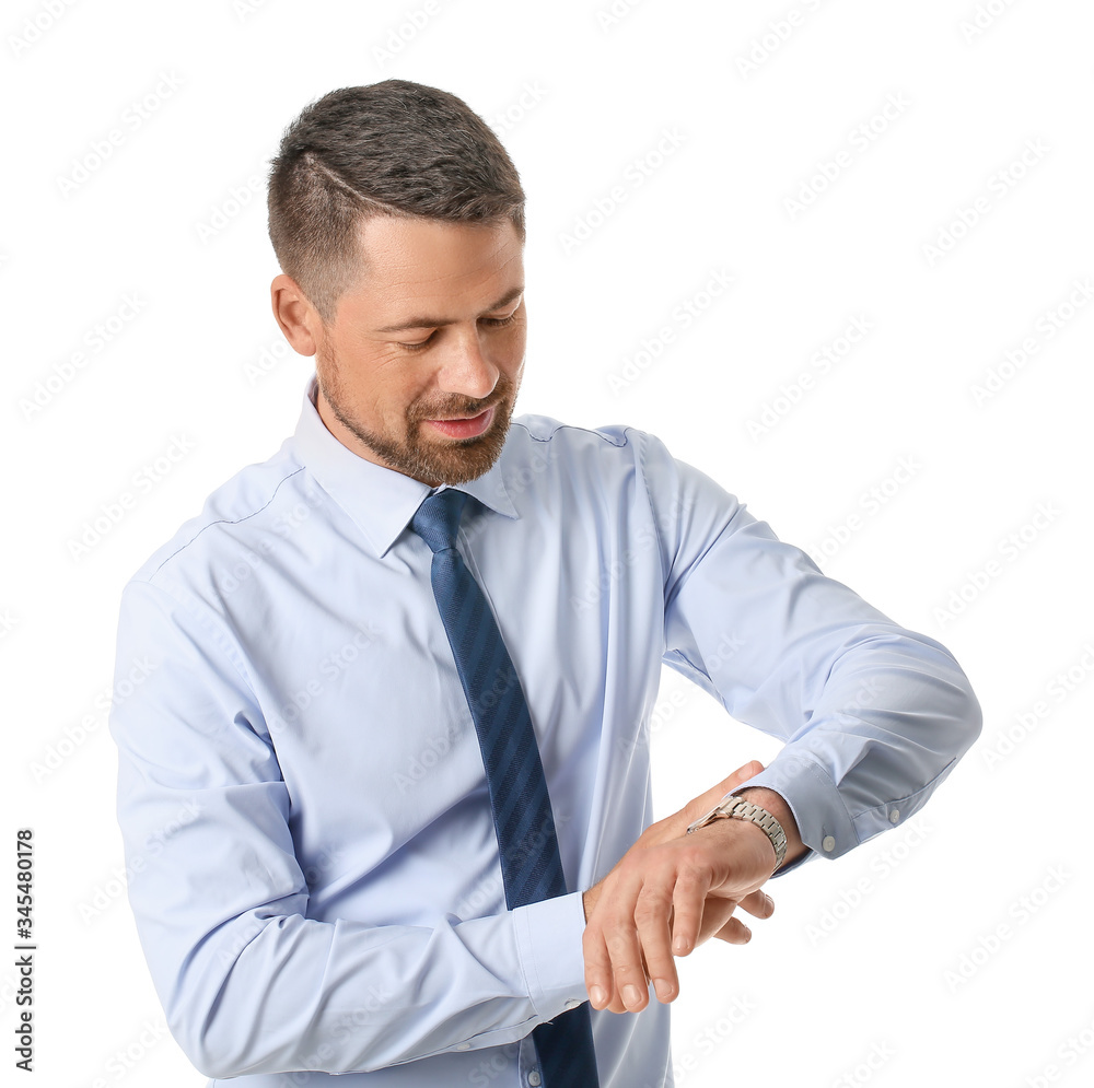 Portrait of handsome businessman looking at his watch on white background