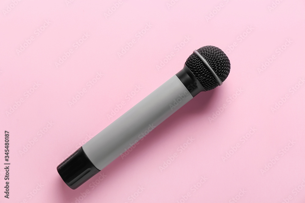 Modern microphone on color background