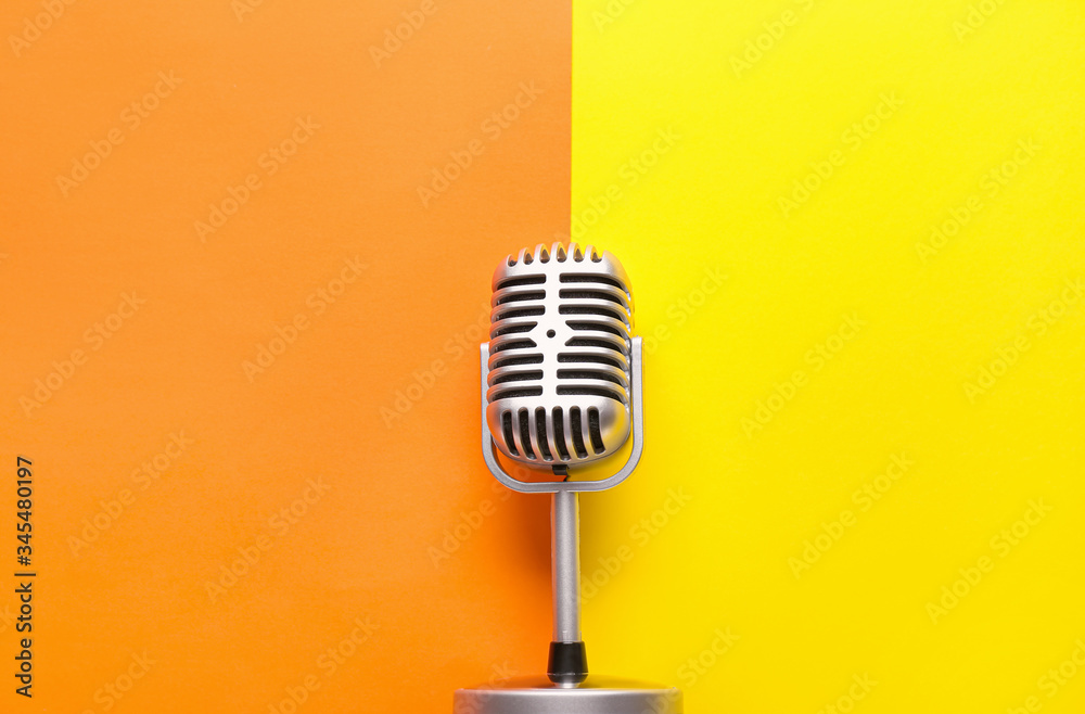 Retro microphone on color background