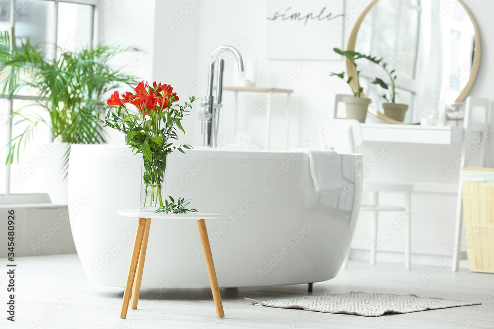 Stylish vase with floral decor in interior of bathroom