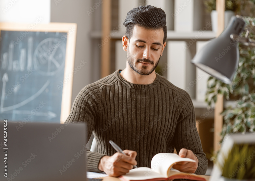 man working on a laptop at home.