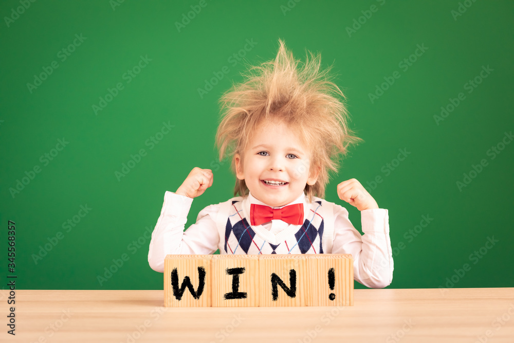 Bright idea! Happy child student against green chalkboard