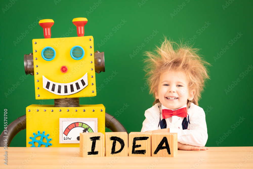 Bright idea! Happy child student against green chalkboard