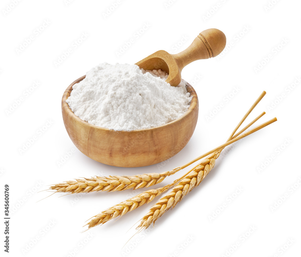 Wheat flour in wooden bowl and ears isolated on white