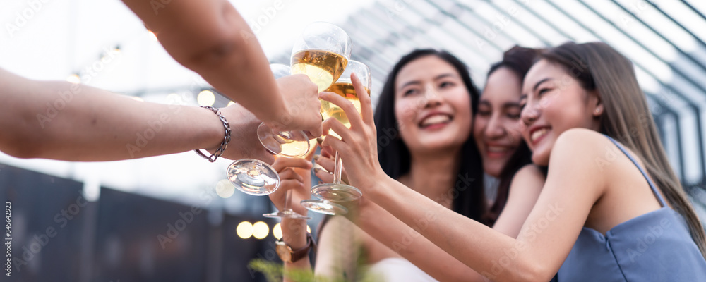 Group of young cute Asian girl gang best friends having party at rooftop restaurant. Girls drinking 