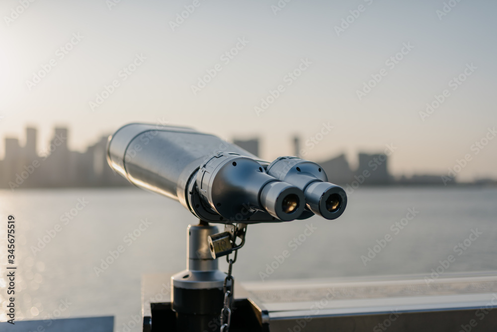 telescope with city skyline