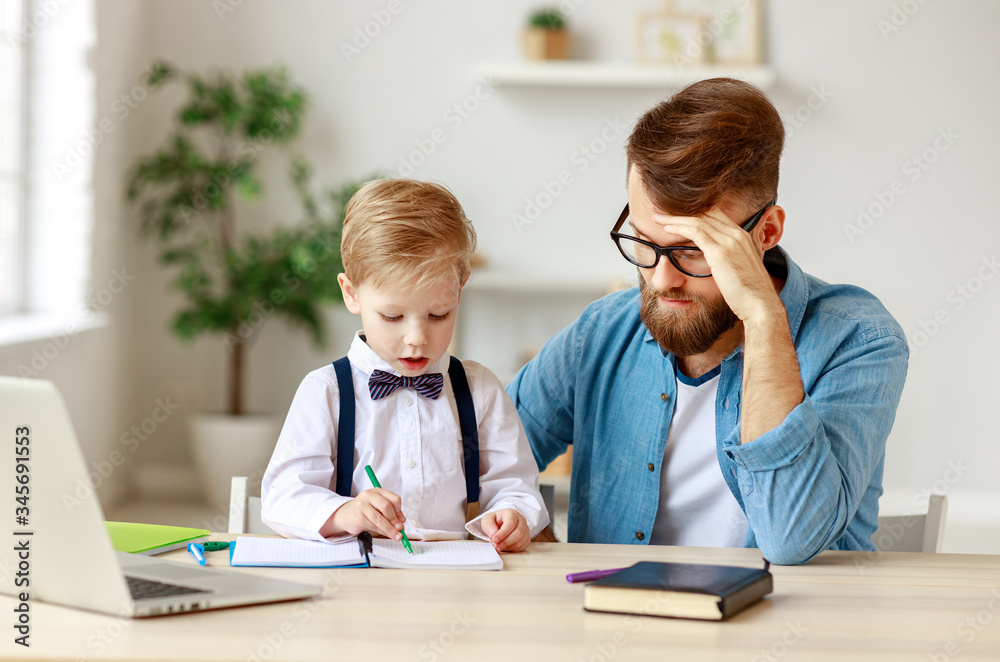  Little boy with father during online education at home.