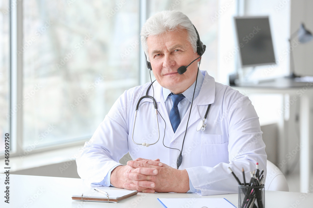 Male doctor giving a consultation online in clinic