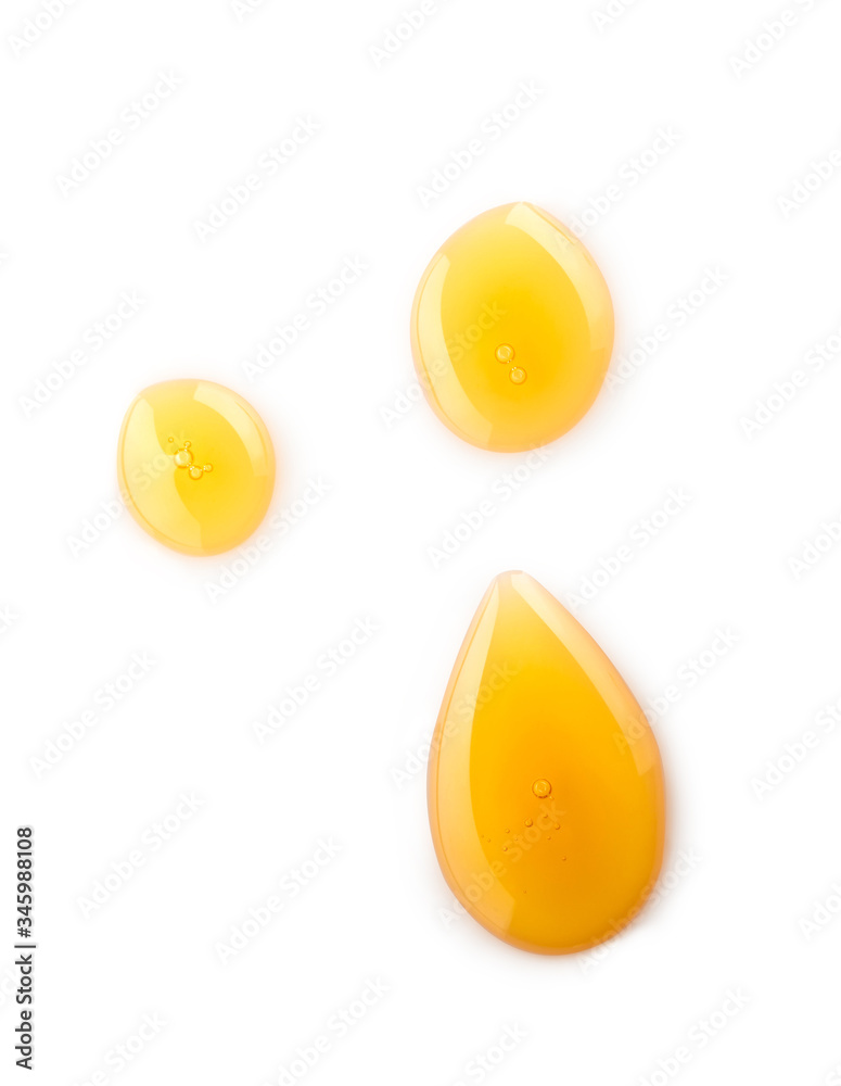 Macro honey drops isolated on white background, File contains a clipping path.