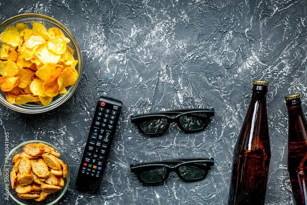 watching movies concept with chips on dark background top view mock up