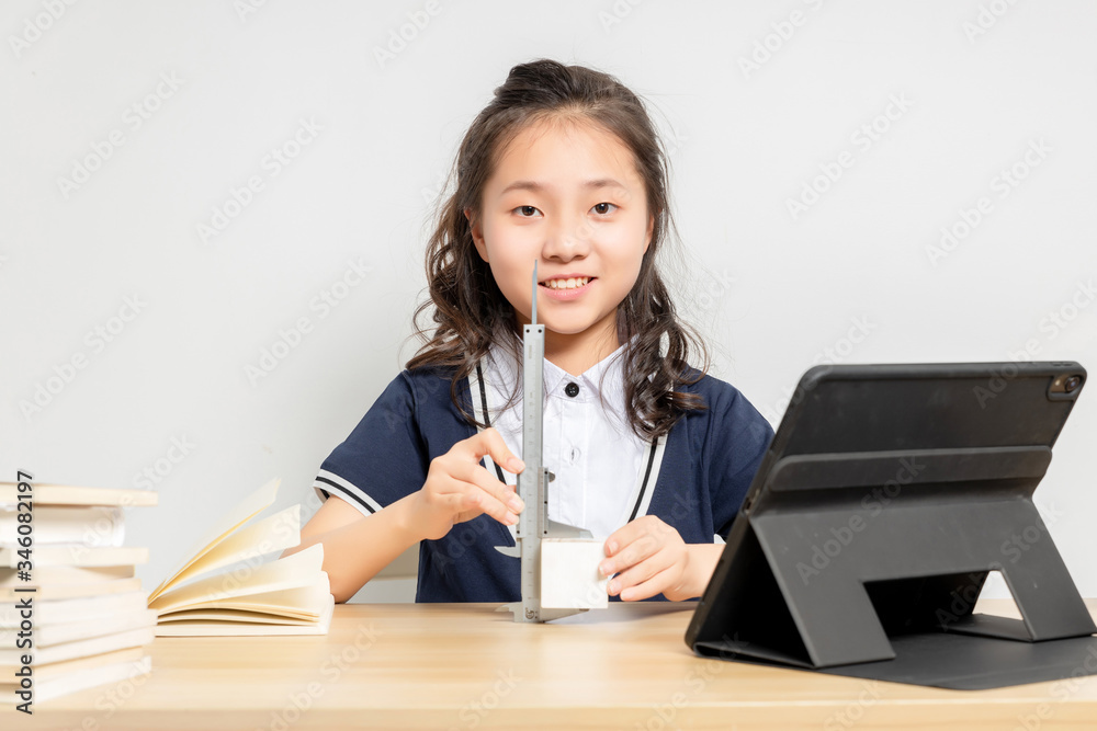 Asian primary school girls doing physics experiments