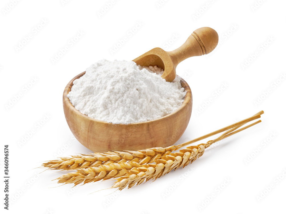 Wheat flour in bowl and spikelets isolated on white