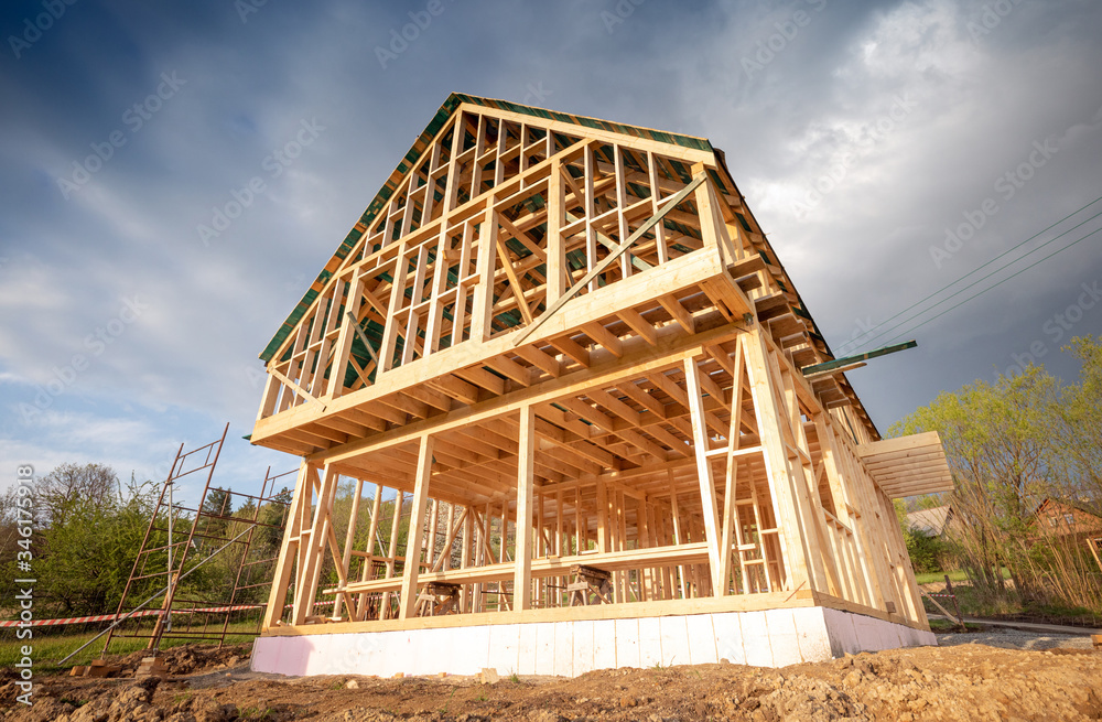 New wooden frame house under construction, outdoor residential home