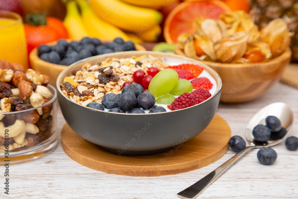 Group Fruits Breakfast mixed vegetables with salad bowl, nuts bowl, strawberry, banana, and pineappl