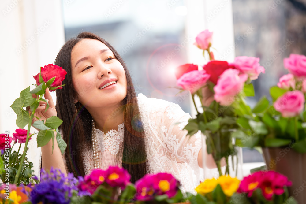 Woman Preparing to trim red and pink roses and beautiful flower arrangements in the home, flower arr