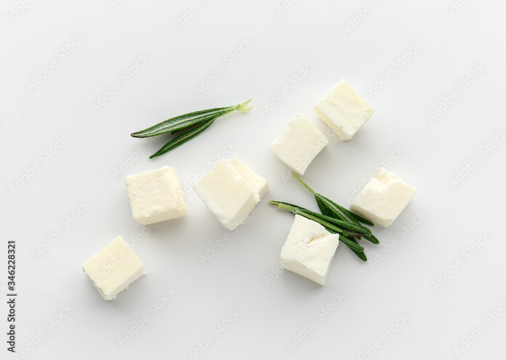 Tasty cut feta cheese on white background